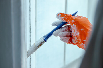 Photo of painting with white paint on wood. Interior painting. Making repairs, painting. White paint © Елена Загорий