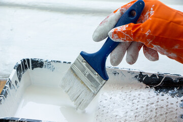 Photo of painting with white paint on wood. Interior painting. Making repairs, painting. White paint © Елена Загорий