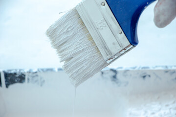 Photo of painting with white paint on wood. Interior painting. Making repairs, painting. White paint © Елена Загорий