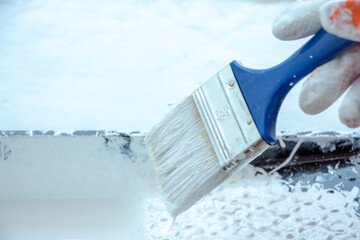 Photo of painting with white paint on wood. Interior painting. Making repairs, painting. White paint © Елена Загорий