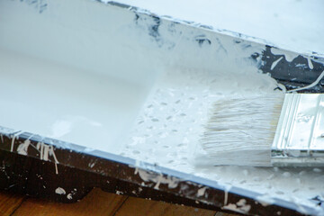 Photo of painting with white paint on wood. Interior painting. Making repairs, painting. White paint © Елена Загорий