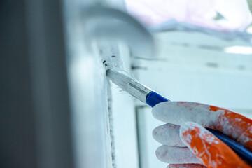 Photo of painting with white paint on wood. Interior painting. Making repairs, painting. White paint © Елена Загорий