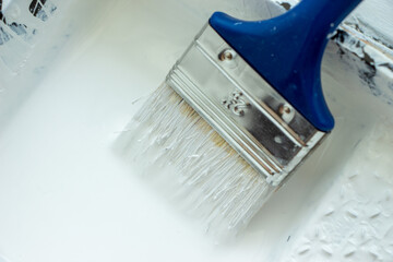 Photo of painting with white paint on wood. Interior painting. Making repairs, painting. White paint © Елена Загорий