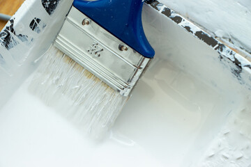 Photo of painting with white paint on wood. Interior painting. Making repairs, painting. White paint © Елена Загорий