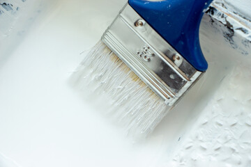 Photo of painting with white paint on wood. Interior painting. Making repairs, painting. White paint © Елена Загорий