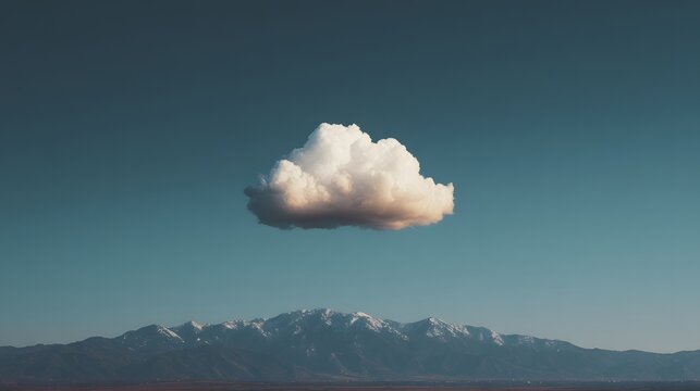 Solitary cloud above a mountain range.