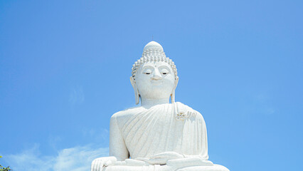 Phuket Big Buddha statue. afternoon light sky and blue ocean are on the back of white Phuket big Buddha is the one of landmarks on Phuket island Thailand.