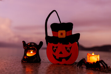 Concept: Halloween beach and ocean background with spider, witch and ghost pumpkin. Dark, scary tone.