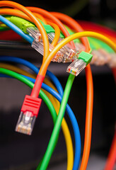 set of brightly multi coloured ethernet network cables, with white tones