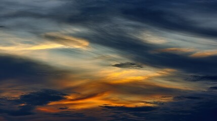 Obraz premium Blue and Orange Cloudy Sky Background with Golden Sunset Light – Hues of Azure and Amber Blending in Clouds, Bathed in Warm Golden Rays of the Setting Sun