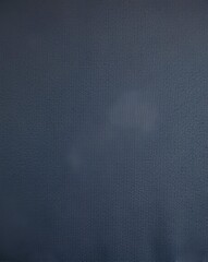 High-resolution macro image of dark blue-gray wool flannel fabric, flat and smooth, displaying fine woven details, soft touch, and subtle elegant texture