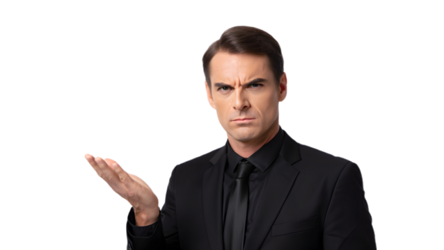 Man in black suit gesturing with open palm against a dark background