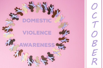 Domestic violence awareness month concept.  Fabric female shapes of different ethnicities come together wearing purple support ribbons to stand against domestic abuse.
