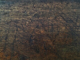 Distressed brown wood texture as background. Scratched vintage wooden surface background.