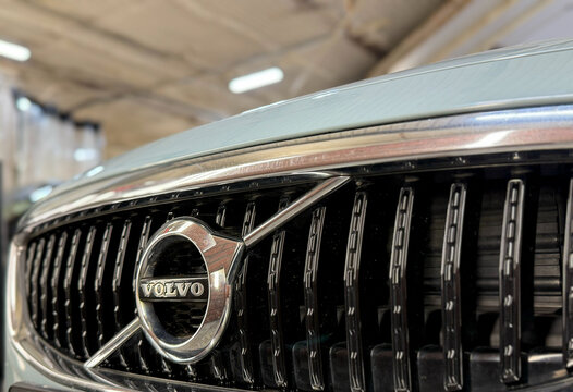 Front view of Volvo badge logo emblem with radiator grill selective focus. Detail of Volvo V40 car. Volvo car  chrome radiator grille with logo in the center. 