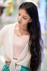Fototapeta premium Chinese girls leisurely strolling through the clothing section of a shopping mall on a holiday