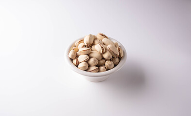 salted pistachios on a white background