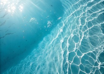 Obraz premium An aerial view captures the serene interplay of light and shadows on a clear turquoise ocean surface showing captivating water textures.