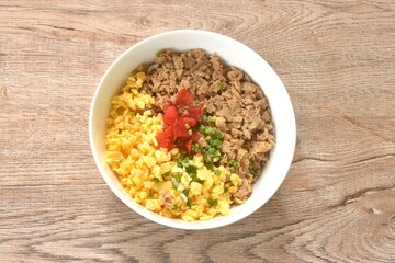 fried chop chicken and sweet egg toppiing red pickled cucumber on rice or tori soboro don japanese food in bowl