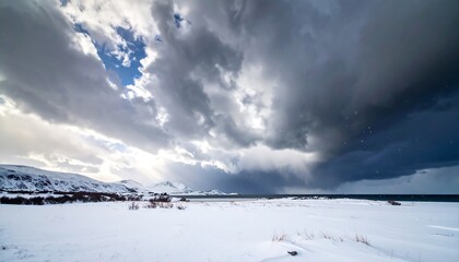 Snowy beach under dramatic sky