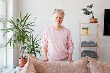 Smiling middle aged mature grey haired woman looking at camera