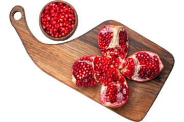 Fresh Pomegranate Pieces on Wooden Cutting Board.