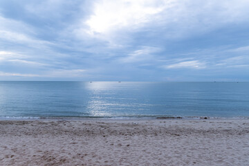 Calm beachfront during twilight with gentle waves and a serene sky in an unidentified coastal location