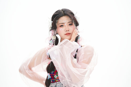 An Eastern girl dressed in the traditional costume of the Hani ethnic minority, which is popular among online influencers.