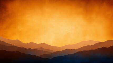 Layers of mountains silhouetted against a fiery orange sunset.