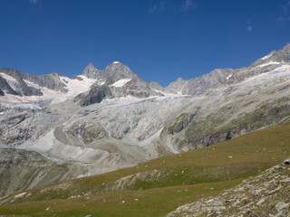 Mettelhorn, Switzerland - August 24th 2024: View towards Obergabelhorn surrounded by rocks, glaciers and moraines