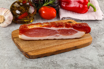 Piece prosciutto crudo over board