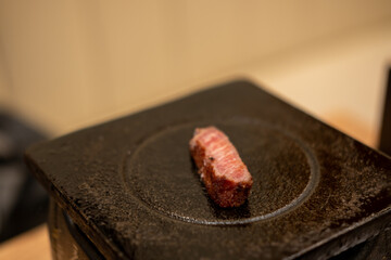 Gyukatsu or beef cutlet. A traditional Japanese food that consists of a deep-fried beef cutlet. on the stone grill