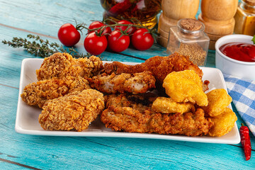 Golden crispy fried chicken mix - wings, drumsticks, nuggets and strips