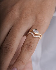 Gold Diamond engagement ring for women and girls lifestyle image with model hand 