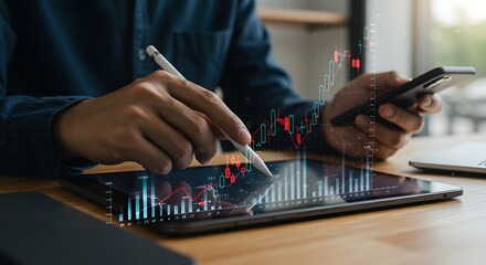 Trader using tablet and smartphone to analyze stock market charts and financial data