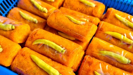 Golden Brown Risoles with Green Chili Pepper, A Delicious Indonesian Snack in a Blue Basket