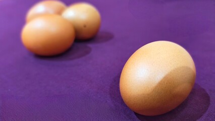 Eggs on Purple Fabric, Group of Raw Eggs Isolated on Purple Backdrop