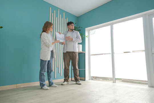 millennial man and woman working in small office, practicing a speech