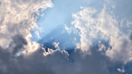 Sun Rays Breaking Through a Cloudy Sky, Natural Light Piercing the Overcast Air