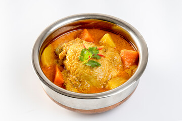 thai yellow chicken curry and roti in stainless steel bowl on a white background