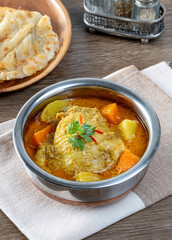 thai yellow chicken curry and roti in stainless steel bowl