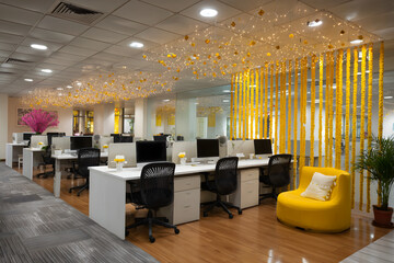 Festive Diwali decorations in modern office workspace with lights and flowers