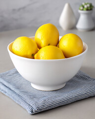 Fresh Lemons in White Bowl on Tablecloth