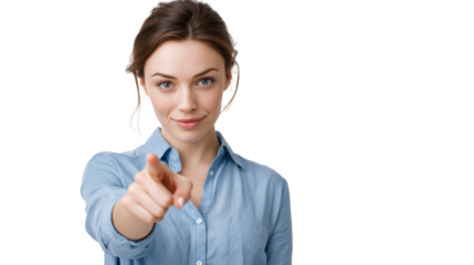 A confident woman pointing at the camera with a smile, wearing a blue shirt, white isolated background.