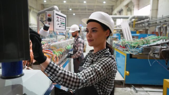 Female engineer operating CNC machine in window factory