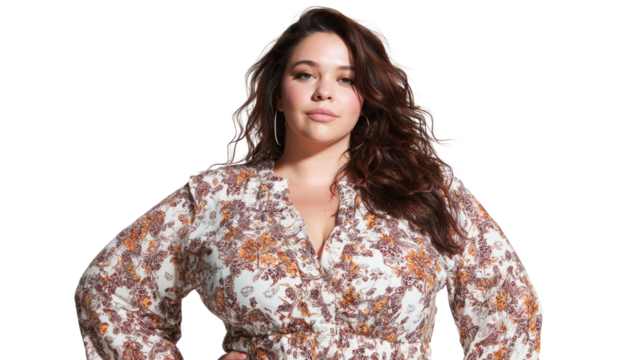Confident woman posing elegantly in a floral dress against a white background.