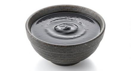 Chinese black sesame soup dessert in ceramic bowl isolated on white background for dessert and food photography