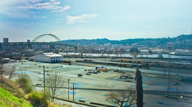 Panoramic cityscape view of portland oregon with bridges, railroad yard and skyline