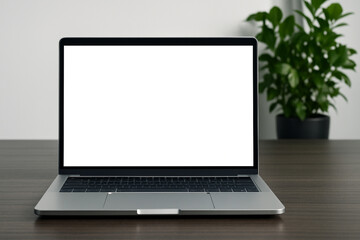 Fototapeta premium Laptop with blank white screen for mockup on a wooden desk in a cozy, sunlit home office setting.