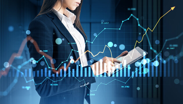 Businesswoman analyzing financial market data on tablet with holographic stock and forex charts over modern digital office background. - Powered by Adobe